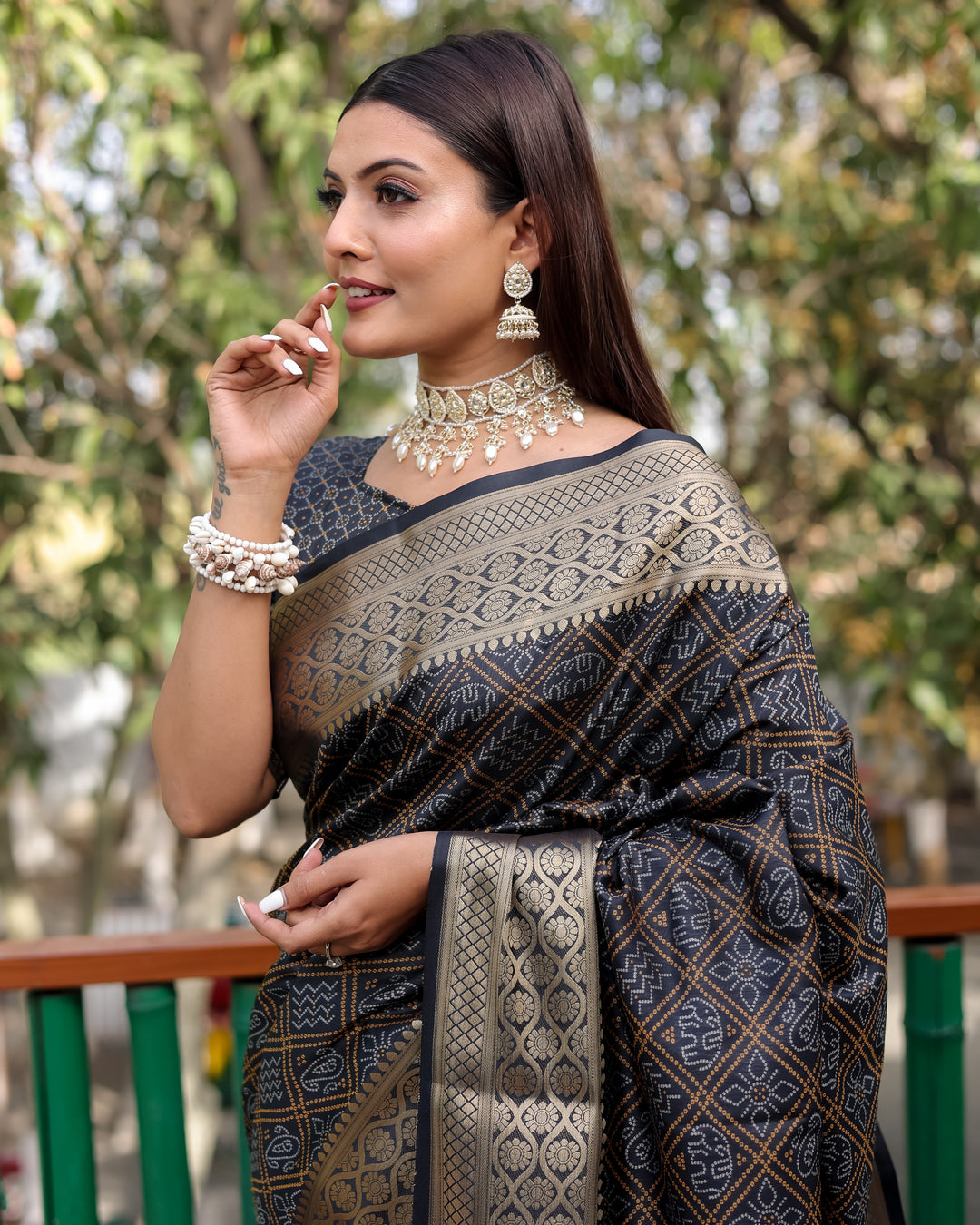 A gorgeous black Pure Handloom Bandhej Patola Silk Saree with intricate patterns, ideal for an elegant evening event.