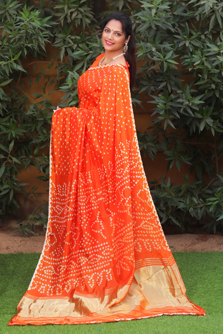 Orange pure Bandhej silk saree with intricate Zari pallu, designed for cultural festivals and celebrations in the USA.