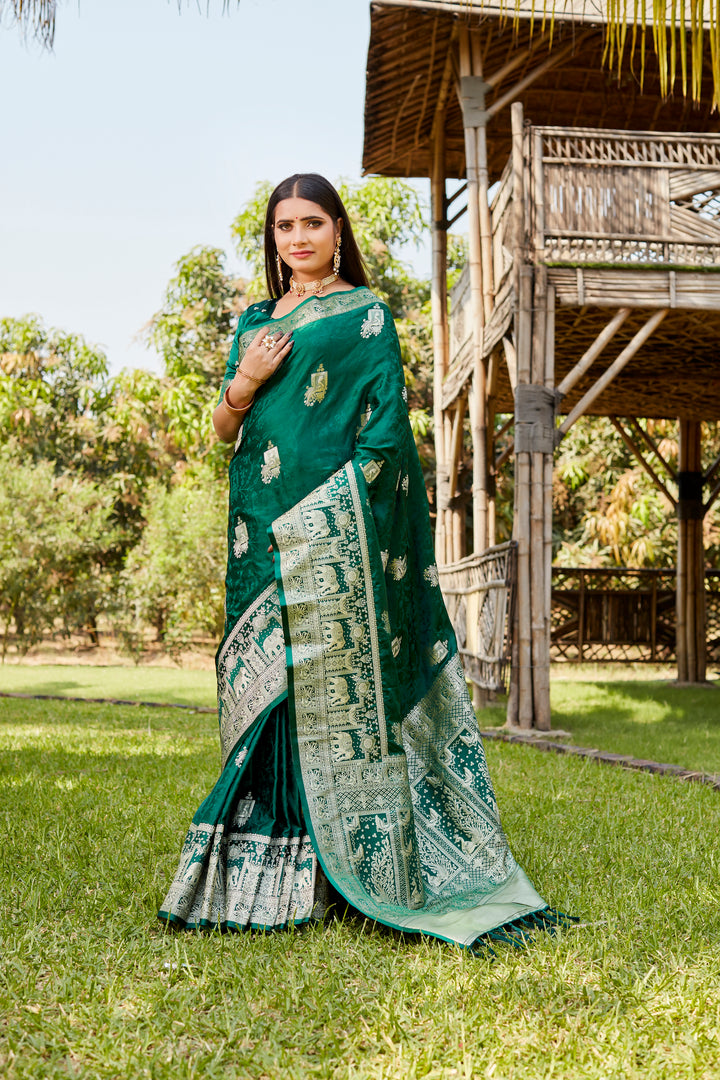 Gorgeous teal-green satin Kanjivaram saree with intricate elephant border design, perfect for weddings and special events.