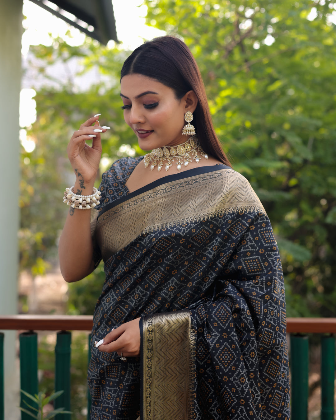 Stunning black Bandhej Patola silk saree featuring intricate patterns and luxurious zari weaving, ideal for formal occasions.