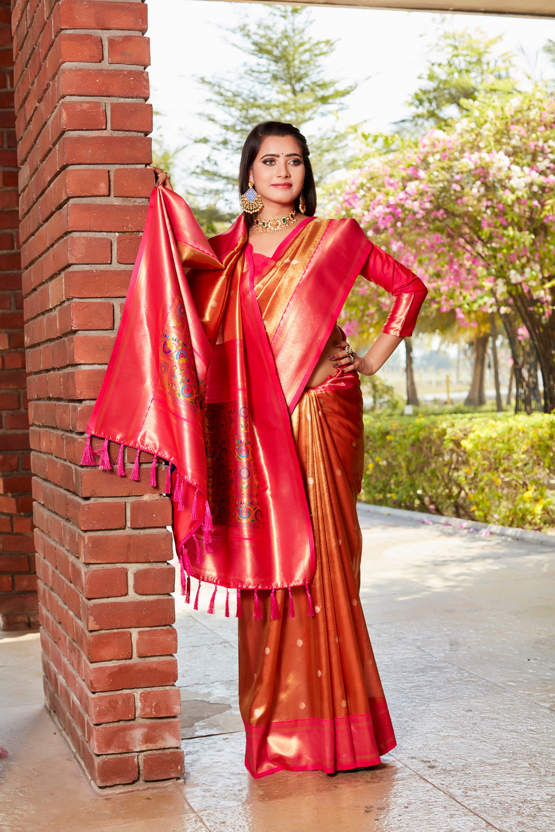 Stunning red tissue silk saree with rich pallu and contrast blouse, ideal for festive occasions.