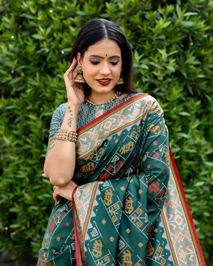 Vibrant sea-blue Bandhej silk saree with matching blouse and zari woven pallu, perfect for luxury events.