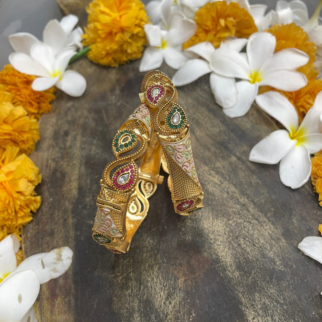 Golden bangles with traditional patterns for a cultural touch.