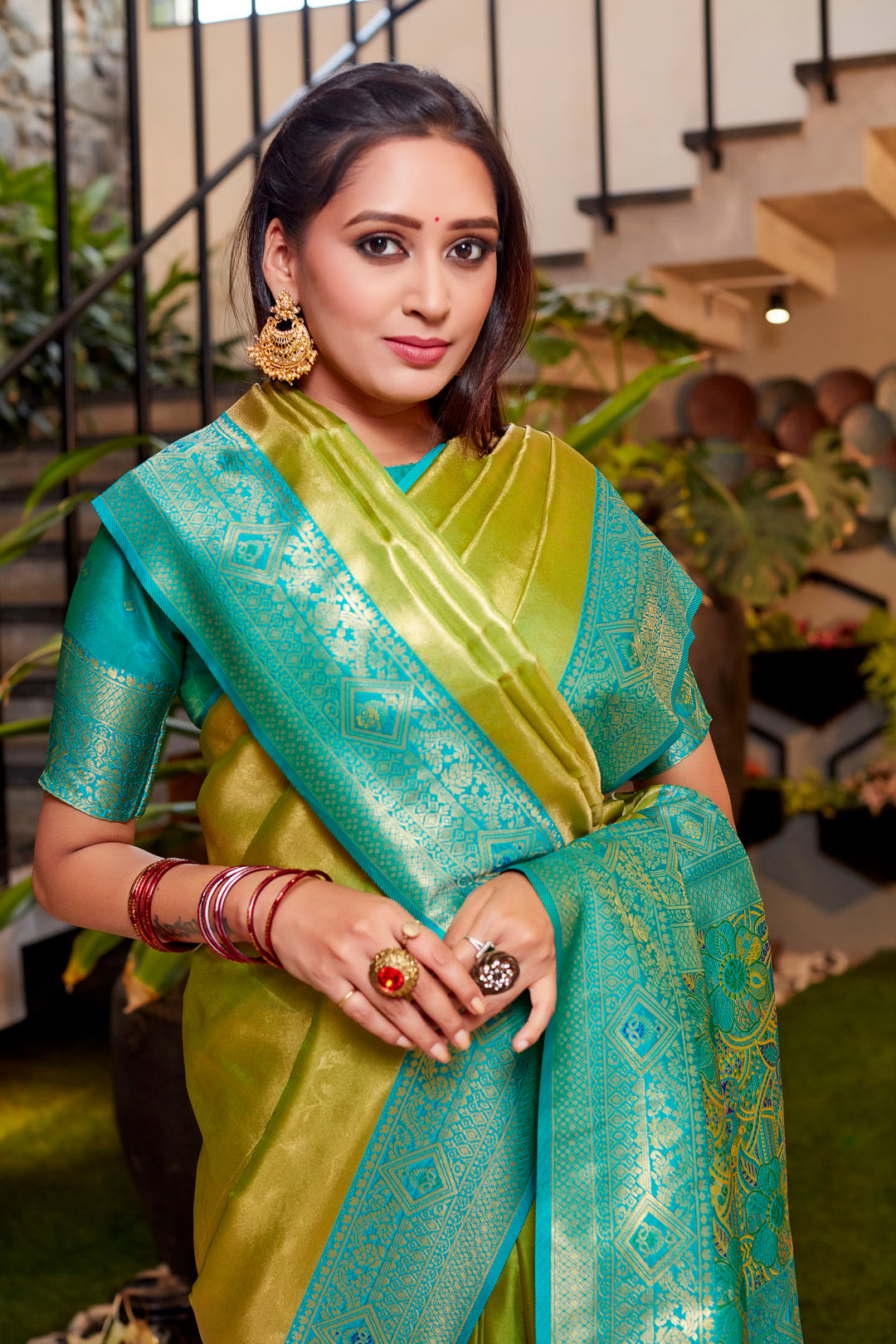 Elegant olive Tissue silk saree with rich weaving and beautiful contrast border.