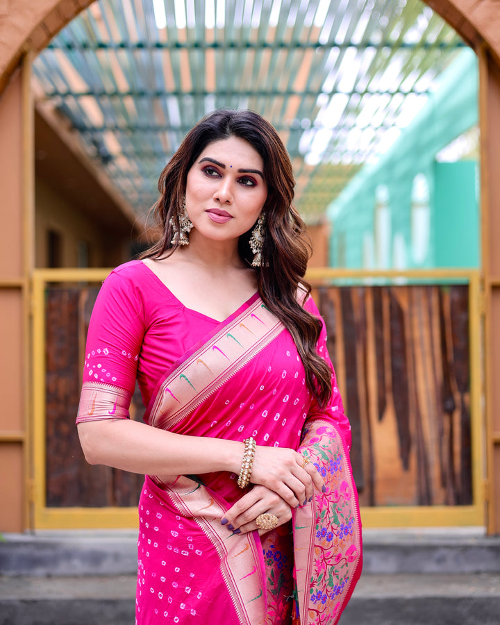 Bright pink Bandhej silk saree with rich zari weaving, Paithani border, and matching tassels, designed for festive occasions.