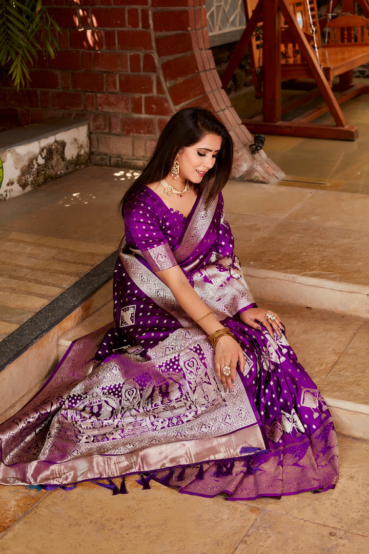 Graceful purple Kanjivaram satin silk saree with beautiful butta work, designed with a woven pallu and intricate border details.