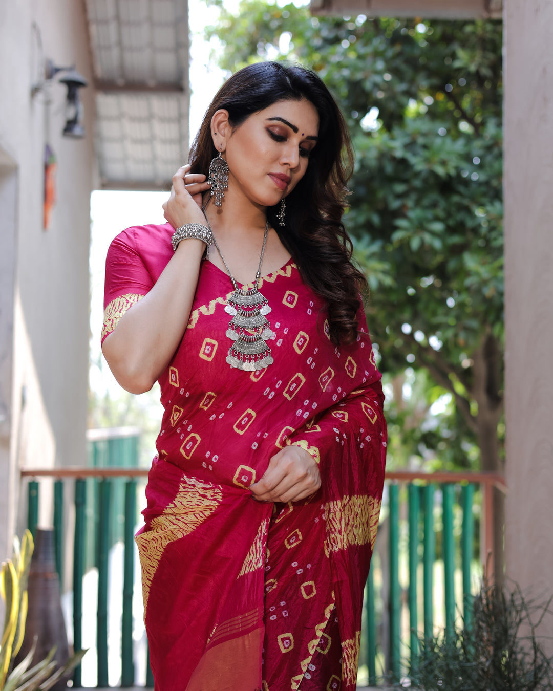 Stunning pink Bandhej silk saree with intricate embroidery and a rich tissue pallu, perfect for festive gatherings.