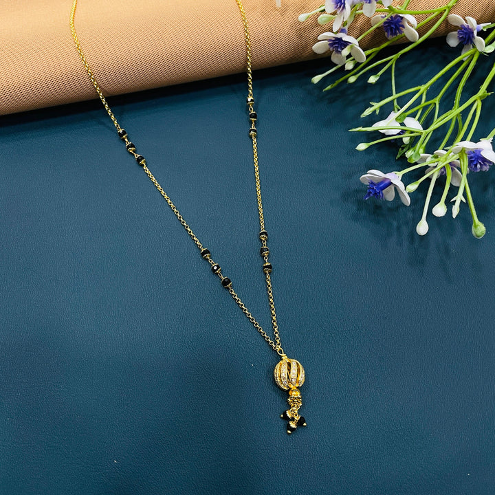 Elegant black and gold mangalsutra, gold alloy, perfect for weddings or daily wear.