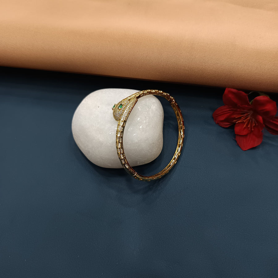 Dainty golden bracelet with intricate details, perfect for formal wear.