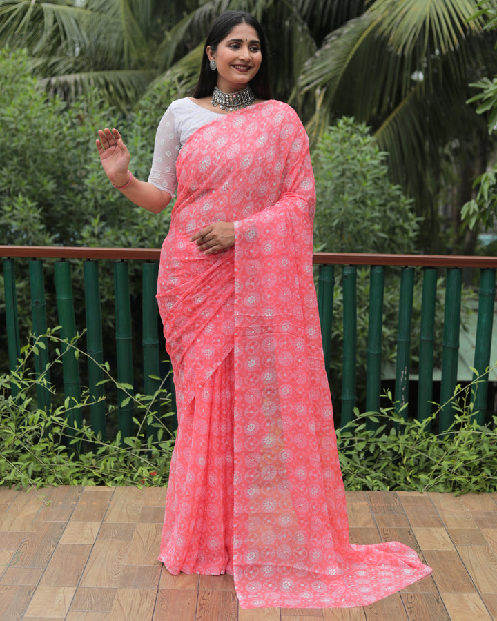 Elegant peach chiffon saree with luxurious foil detailing, offering a chic and radiant look.