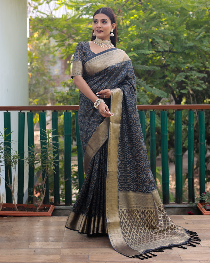 Richly woven black Patola silk saree showcasing a vibrant pallu, perfect for festive and cultural celebrations.