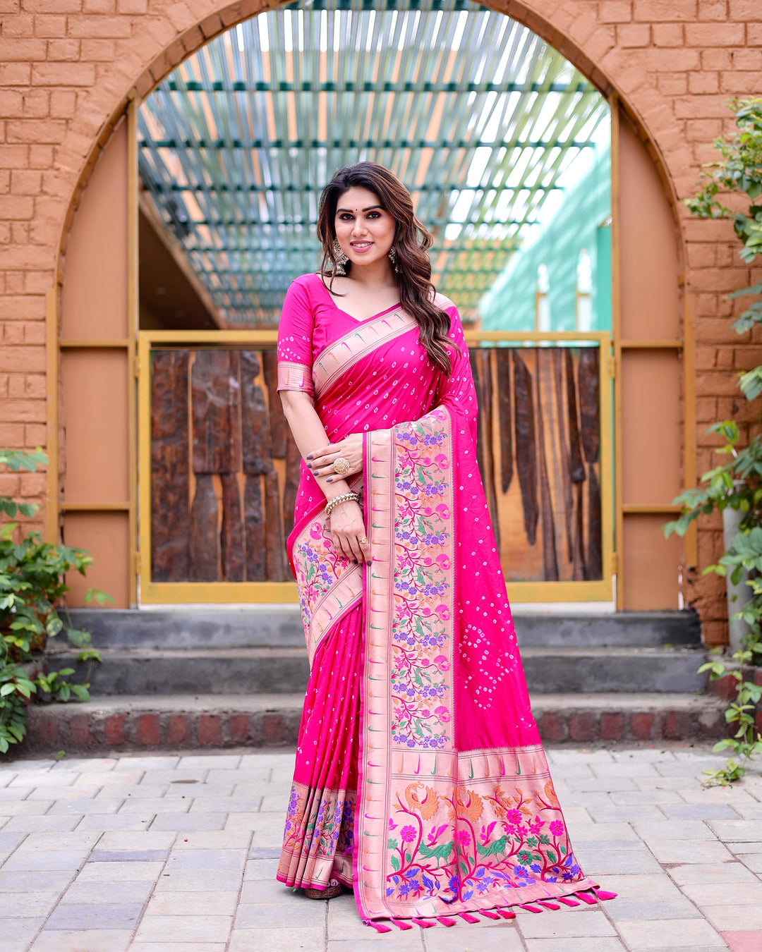 Bright pink Paithani silk saree with intricate zari details and a traditional Paithani border, ideal for grand celebrations.