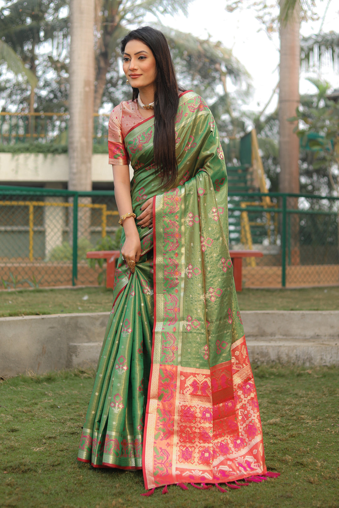 Elegant green organza saree with a lightweight Ikkat Patola design, perfect for festive occasions.