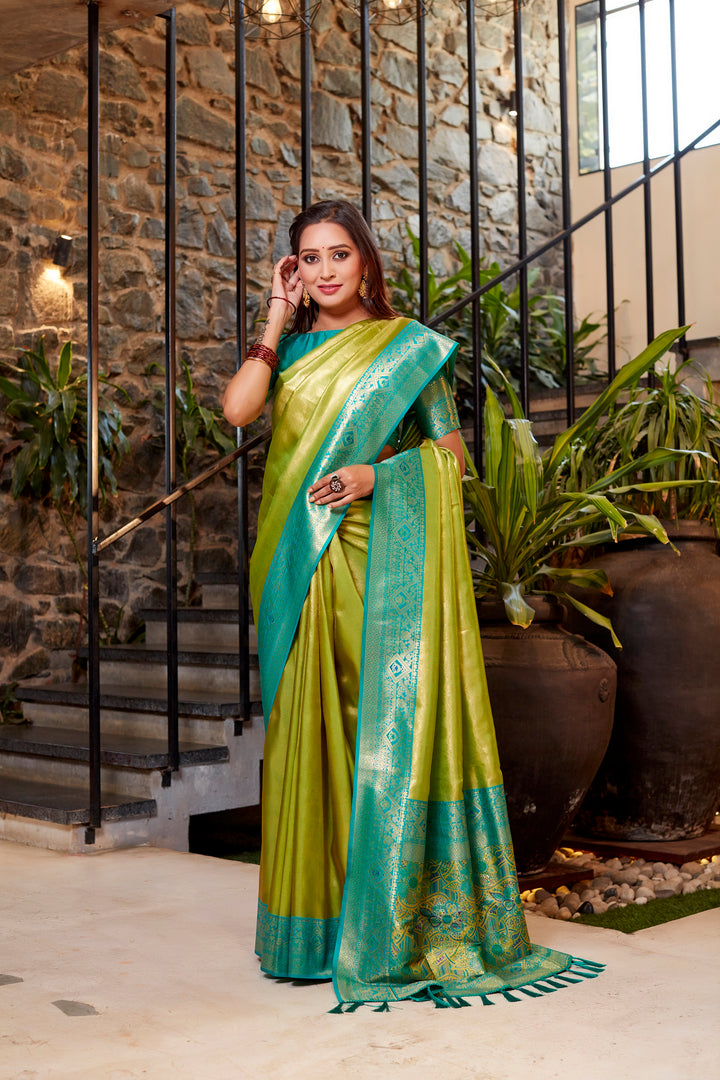 Olive Tissue silk saree with delicate weaving and vibrant contrast border design.