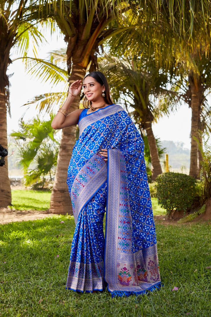 Rich purple Gharchola Bandhej silk saree with intricate zari and meenakari borders, designed for traditional and festive occasions.