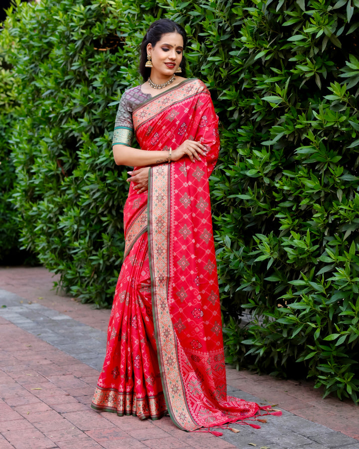 The stunning red Ikkat Patola silk saree, complete with rich Zari weaving and intricate detailing, is a perfect choice for festive events.