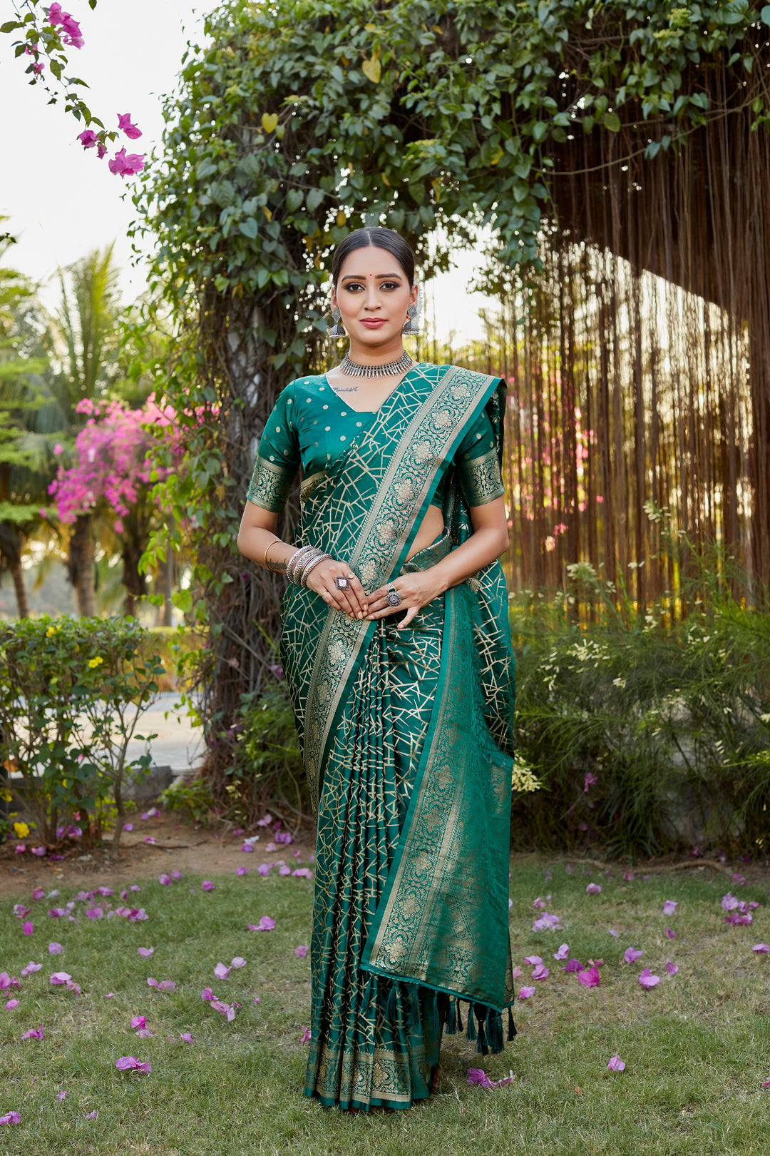 Beautiful dark-green Kanjivaram soft satin silk saree with intricate butta work, perfect for luxury wear and celebrations.