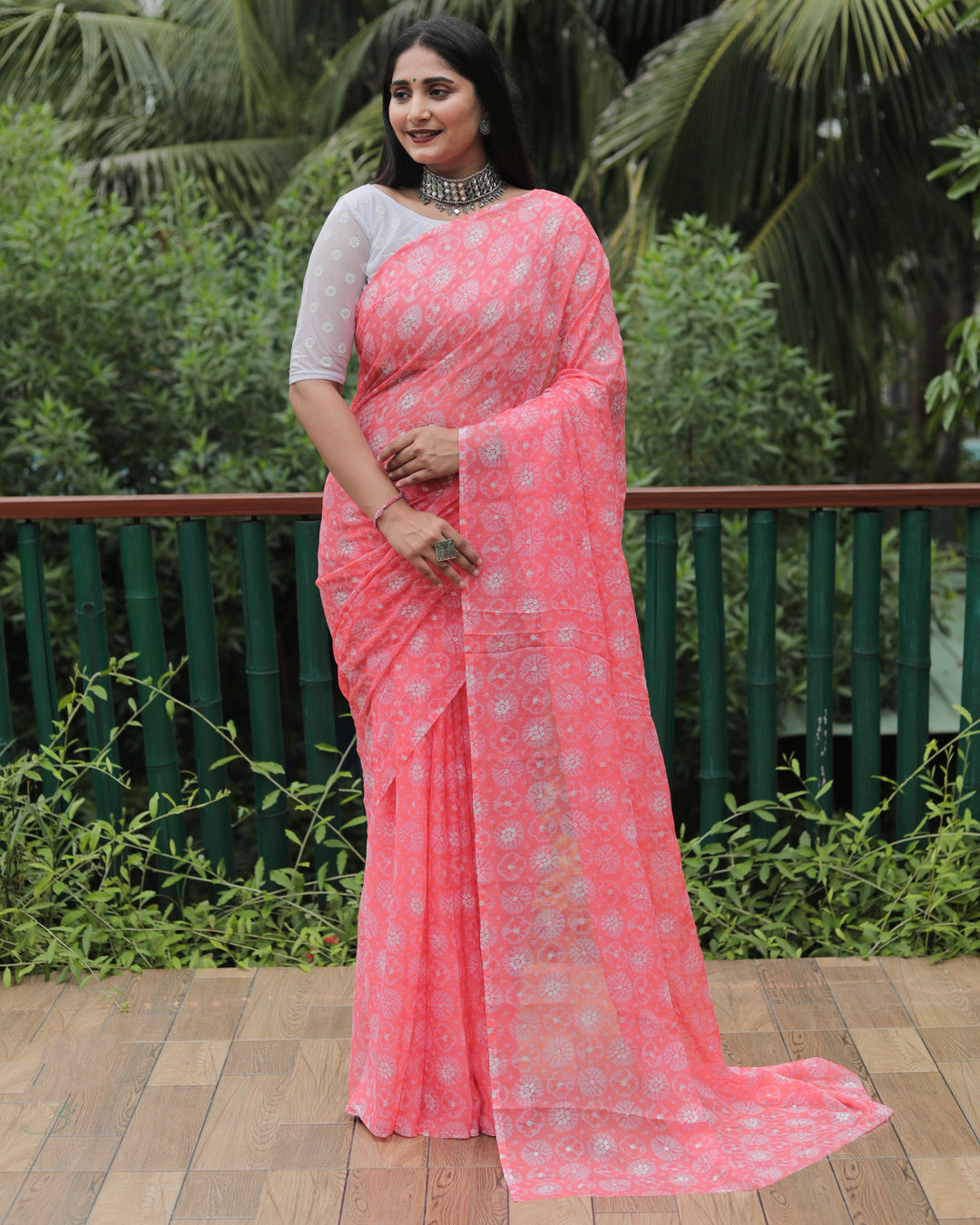 Graceful peach chiffon saree with intricate foil detailing, perfect for weddings and parties.