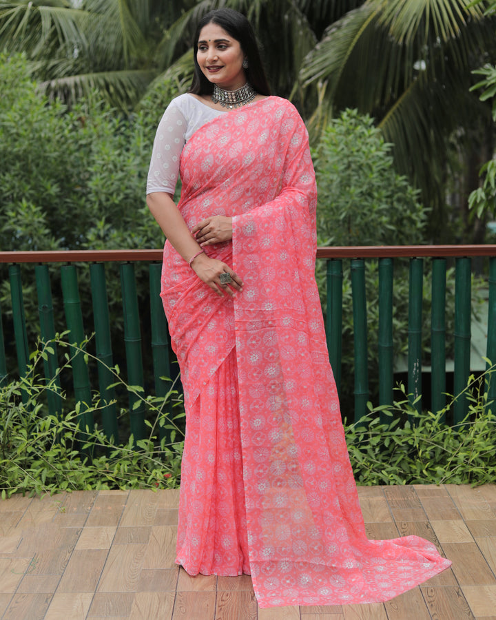 Graceful peach chiffon saree with intricate foil detailing, perfect for weddings and parties.