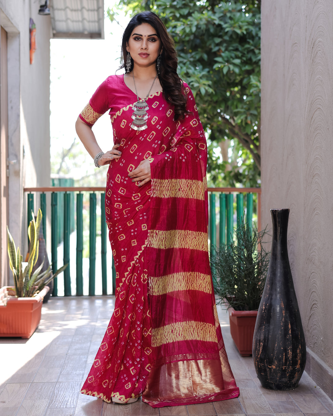 Dazzling pink Bandhej silk saree featuring intricate traditional work and a luxurious tissue pallu, perfect for any celebration.