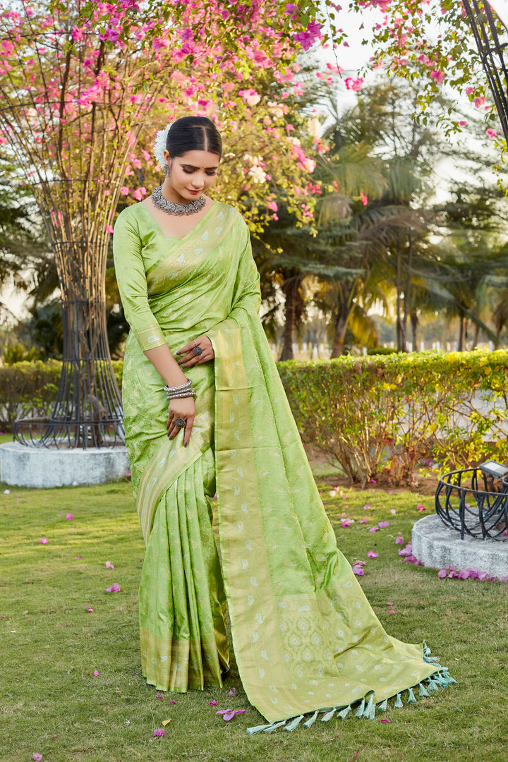 Elegant light-green Kanjivaram saree featuring butta work and woven pallu, ideal for cultural celebrations.