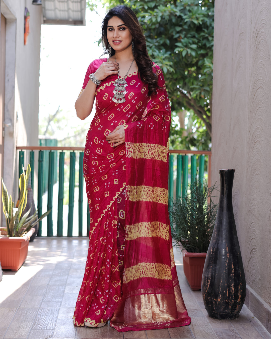 Vibrant pink Bandhej silk saree with beautiful Zari work and Sibory motifs, perfect for weddings and celebrations.