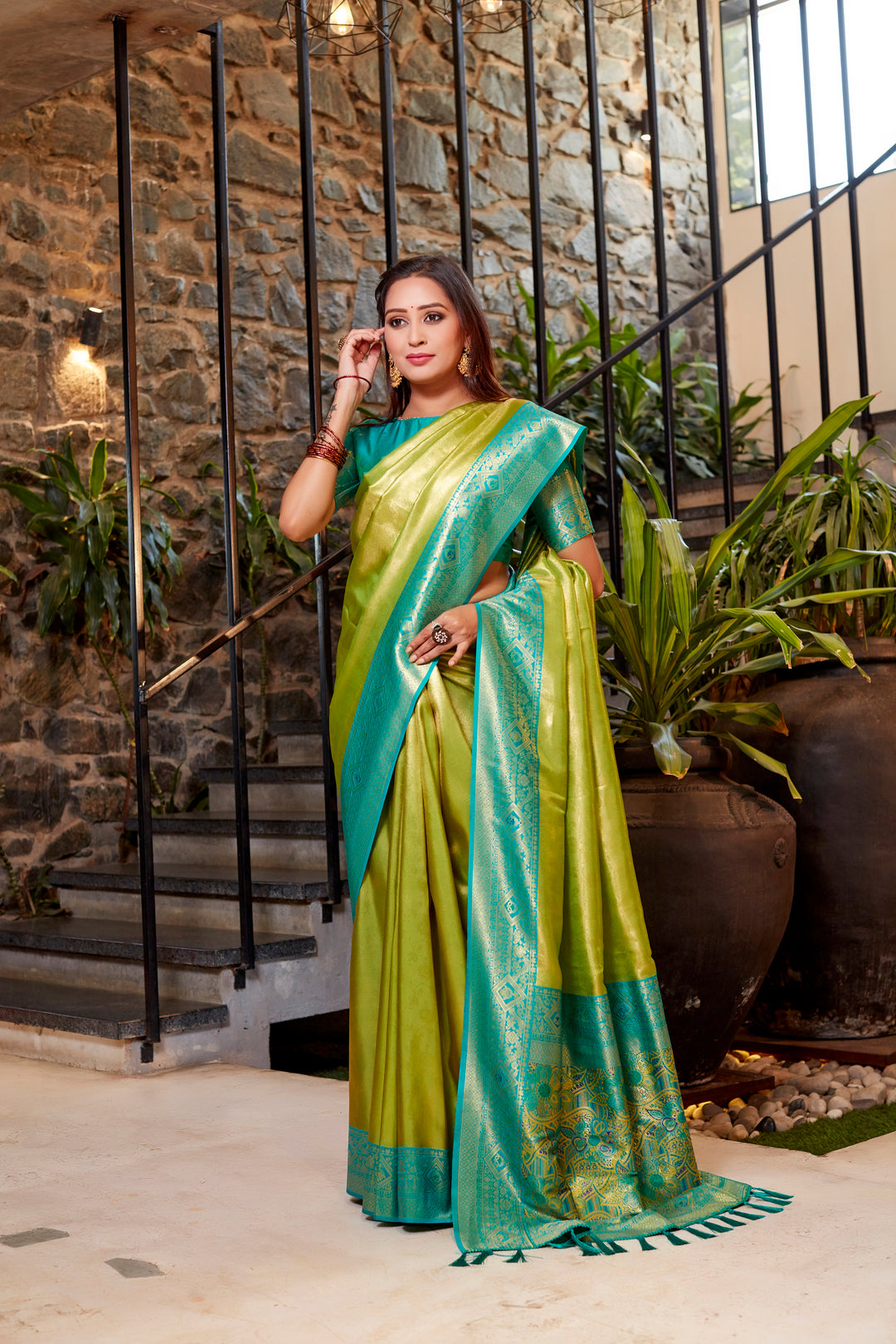 Stunning olive Tissue silk saree with fine weaving and striking contrast border.