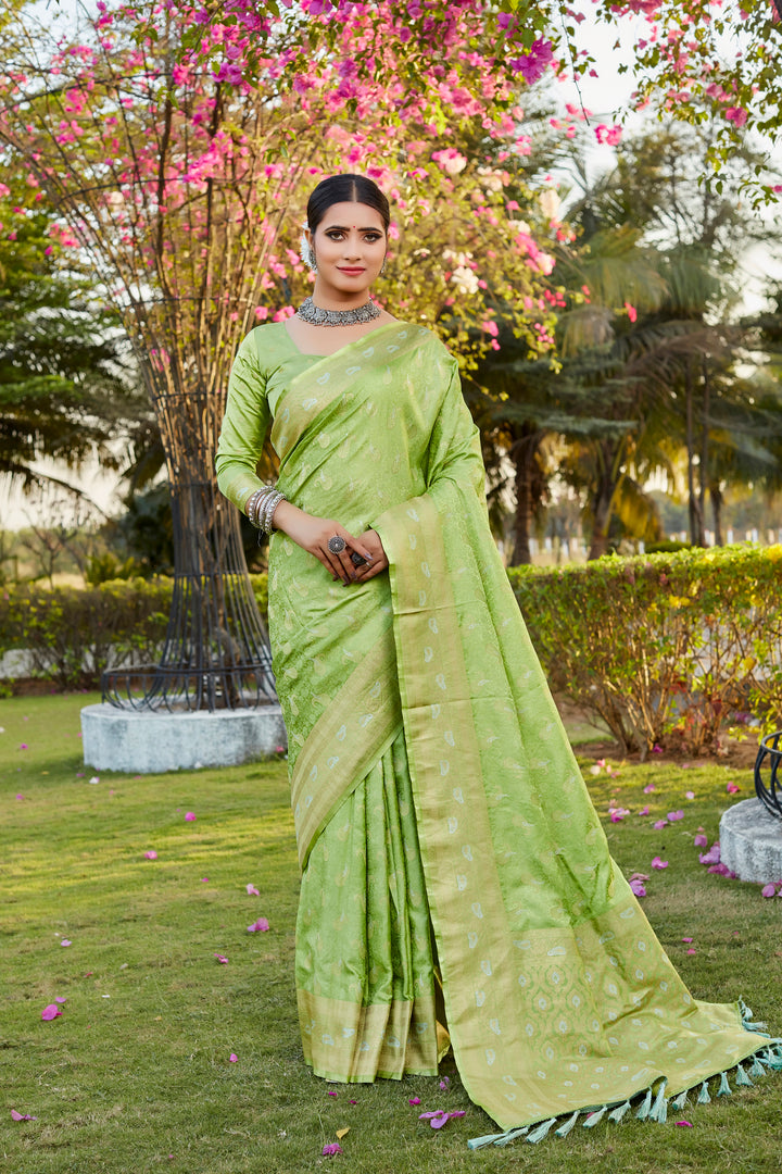 Graceful light-green satin silk Kanjivaram saree with intricate butta design and woven pallu, perfect for festivities.