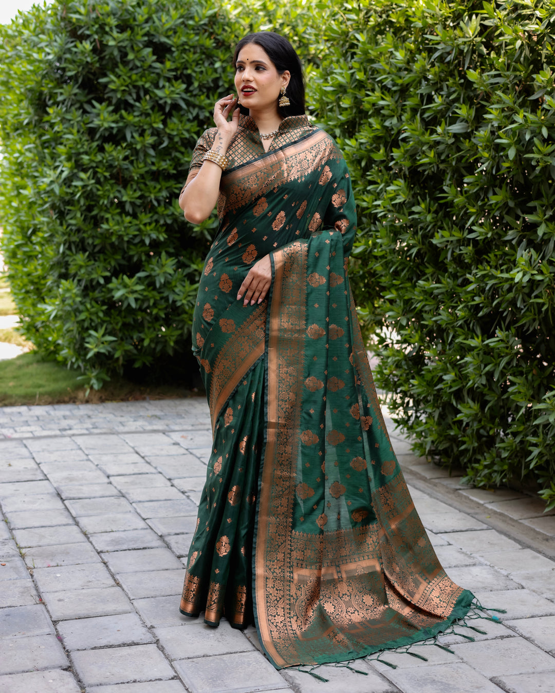 Dark green soft silk saree with contrast copper border and woven pallu, perfect for cultural and festive events.