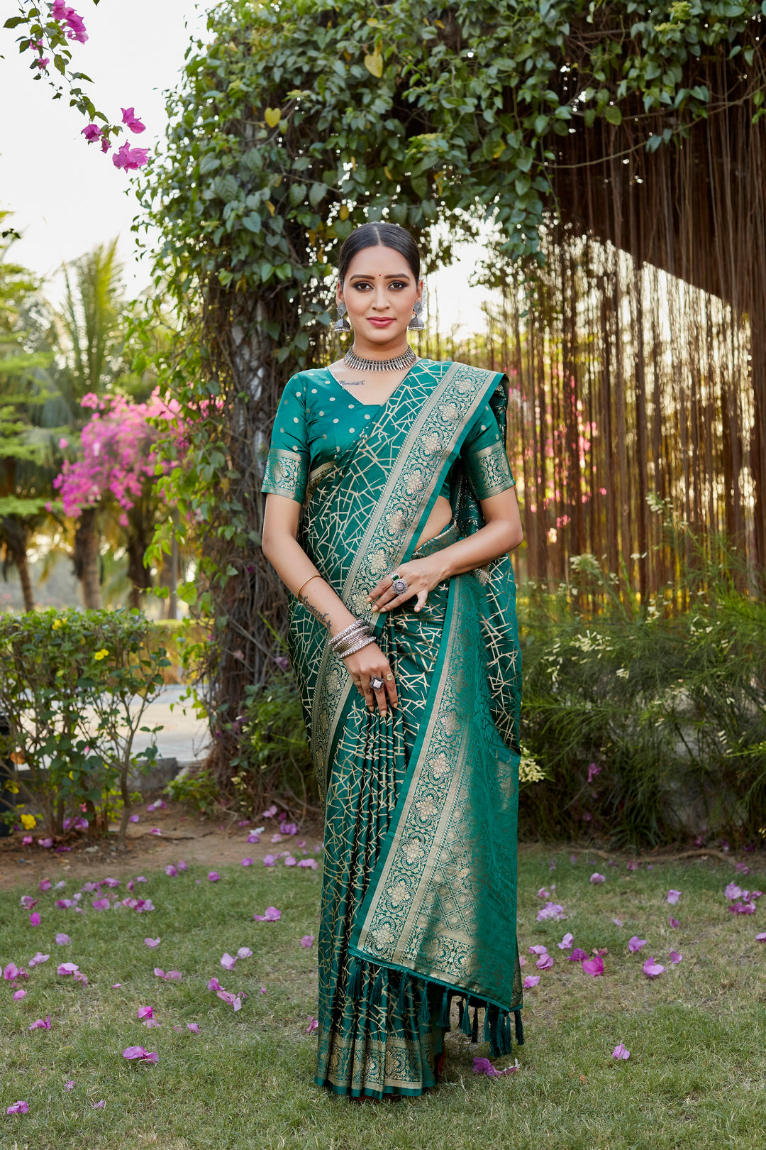 Classic dark-green Kanjivaram soft satin silk saree with detailed butta work, ideal for weddings and traditional wear.