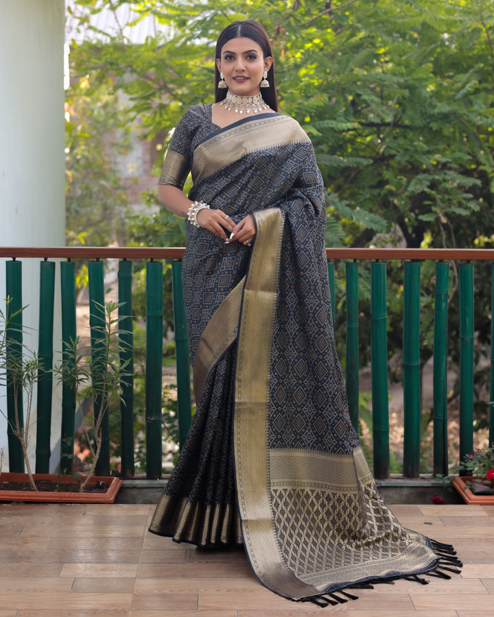 Traditional black Bandhej silk saree with all-over zari weaving and contrast zari borders, reflecting timeless elegance.