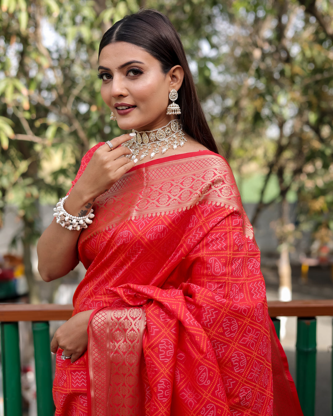 A stunning red Pure Handloom Bandhej Patola Silk Saree with intricate patterns, ideal for an Indian wedding.