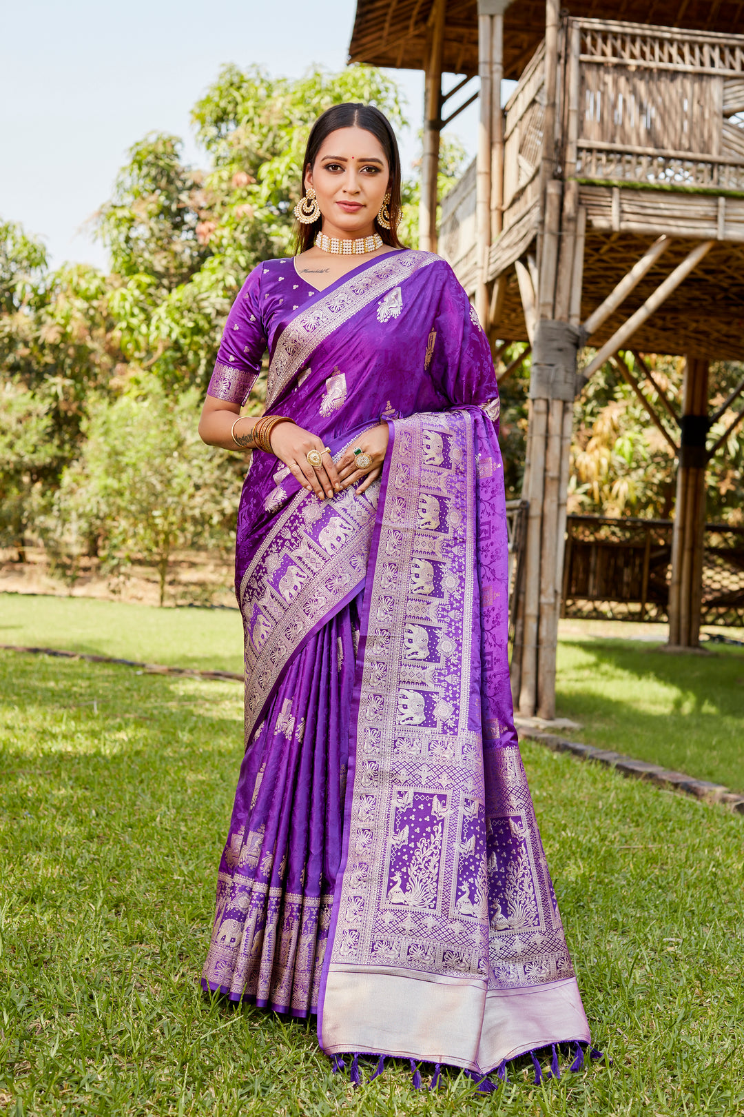 Gorgeous purple satin Kanjivaram saree featuring an intricate elephant border, perfect for weddings and festive events.