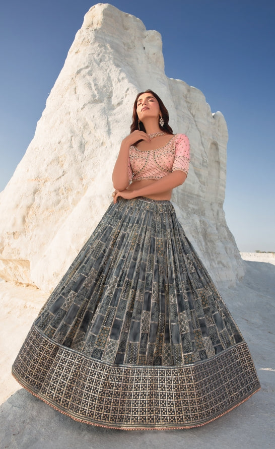 Chic grey and pink lehenga choli designed for brides, featuring an embroidered blouse and elegant matching dupatta.