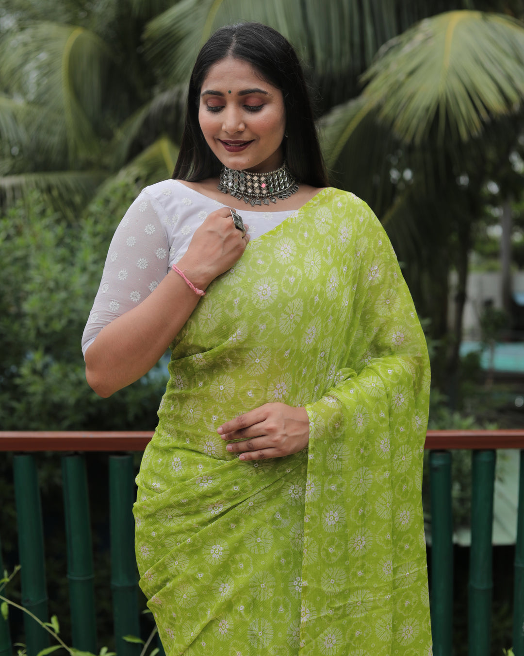 Elegant light green chiffon saree with luxurious foil accents, adding charm to any celebration.