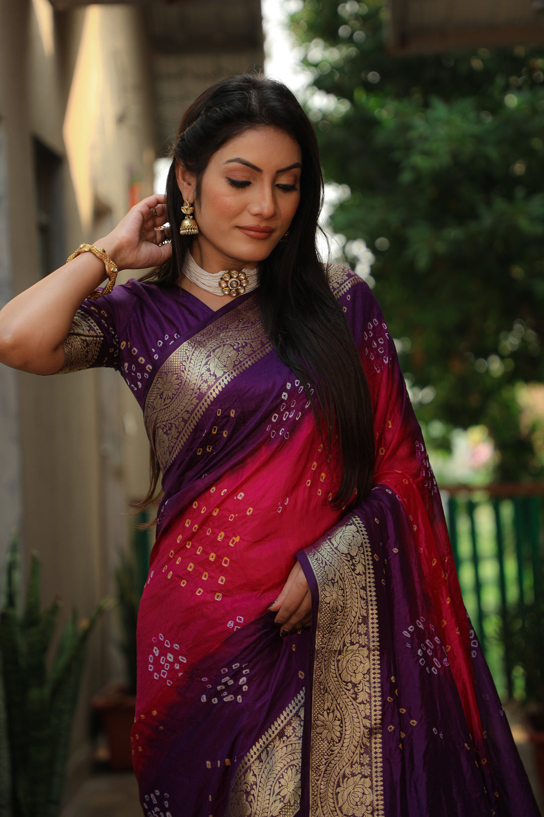 Bright orange Bandhej Tapeta saree with traditional weaving, perfect for weddings.