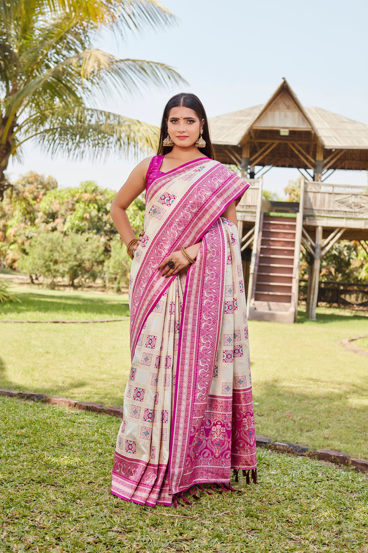 Pale-pink Kanjivaram soft silk saree with intricate designer borders and elegant traditional design.