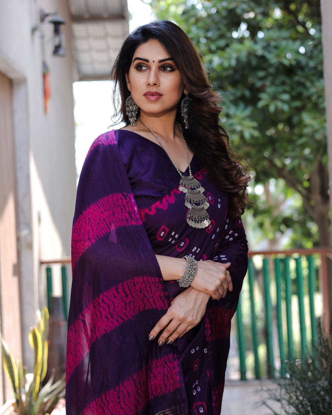 Deep dark purple Bandhej silk saree with intricate Zari weaving and a stunning tissue pallu, designed for celebrations.