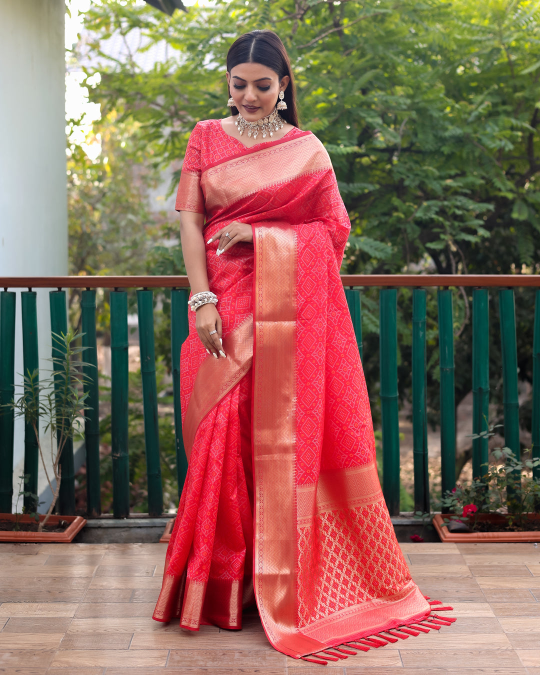 Richly woven red Patola silk saree with a vibrant pallu, ideal for weddings and cultural celebrations.