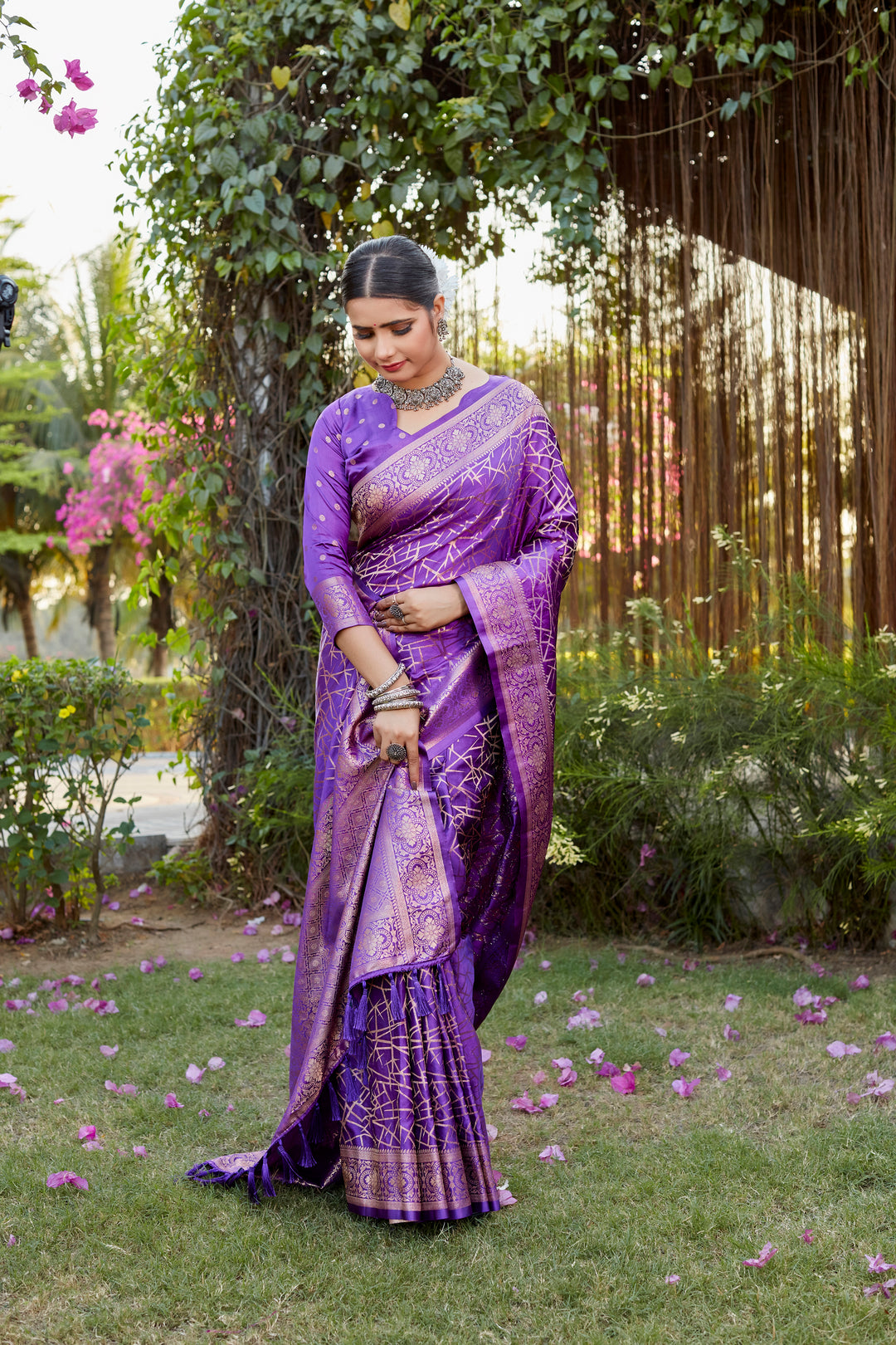 Stunning purple Kanjivaram soft satin silk saree with detailed butta work, ideal for traditional and luxury wear.