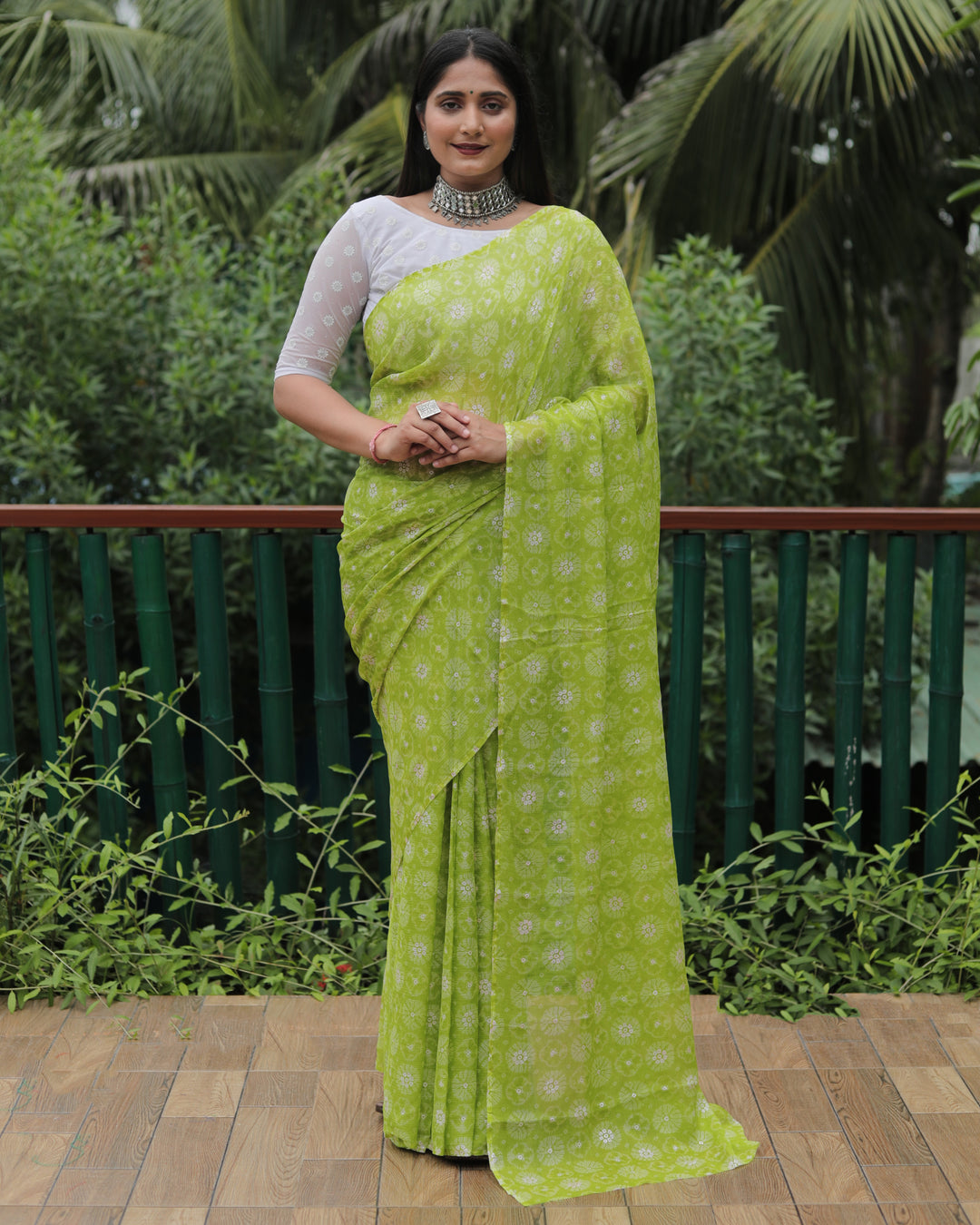 Graceful light green chiffon saree with delicate foil detailing, ideal for weddings and parties.