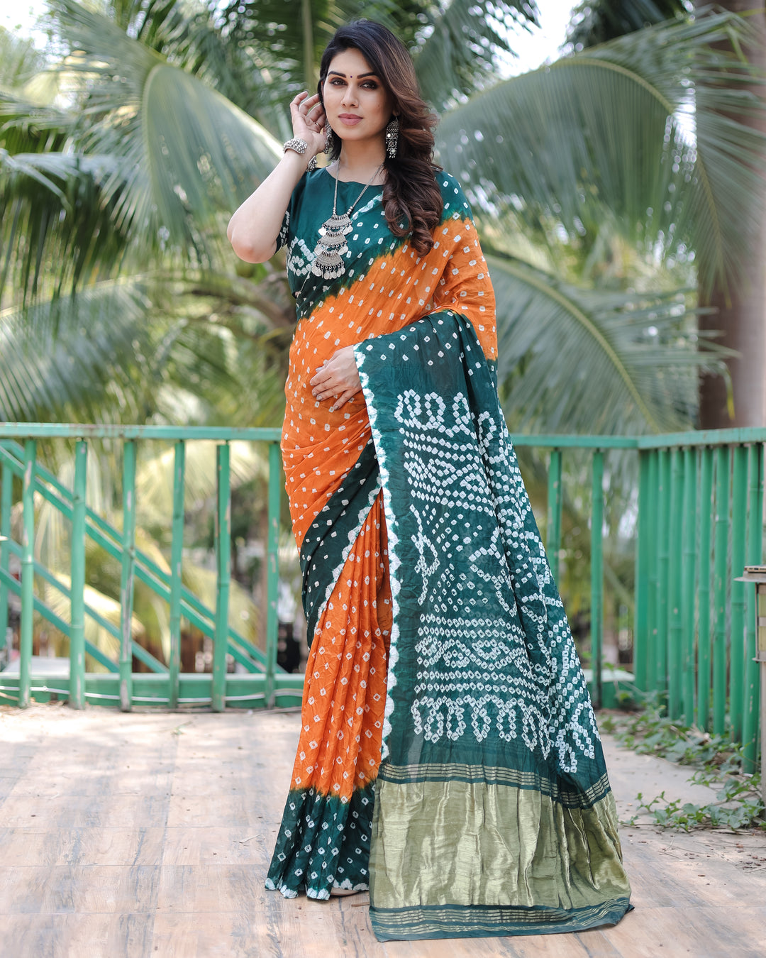 Elegant Orange Bandhej Silk Drapes with Zari Tissue Pallu and blouse piece for a stylish, festive look.