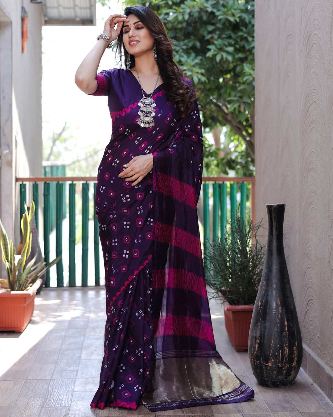 Dark purple Bandhej silk saree with luxurious Zari and Sibory motifs, designed for those special occasions.