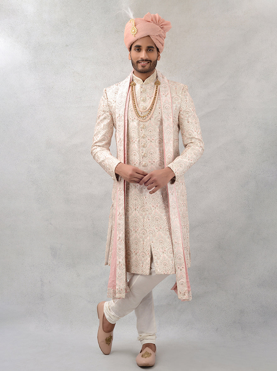 Experience the richness of this cream and gold embroidered sherwani, a perfect choice for grooms in the USA.