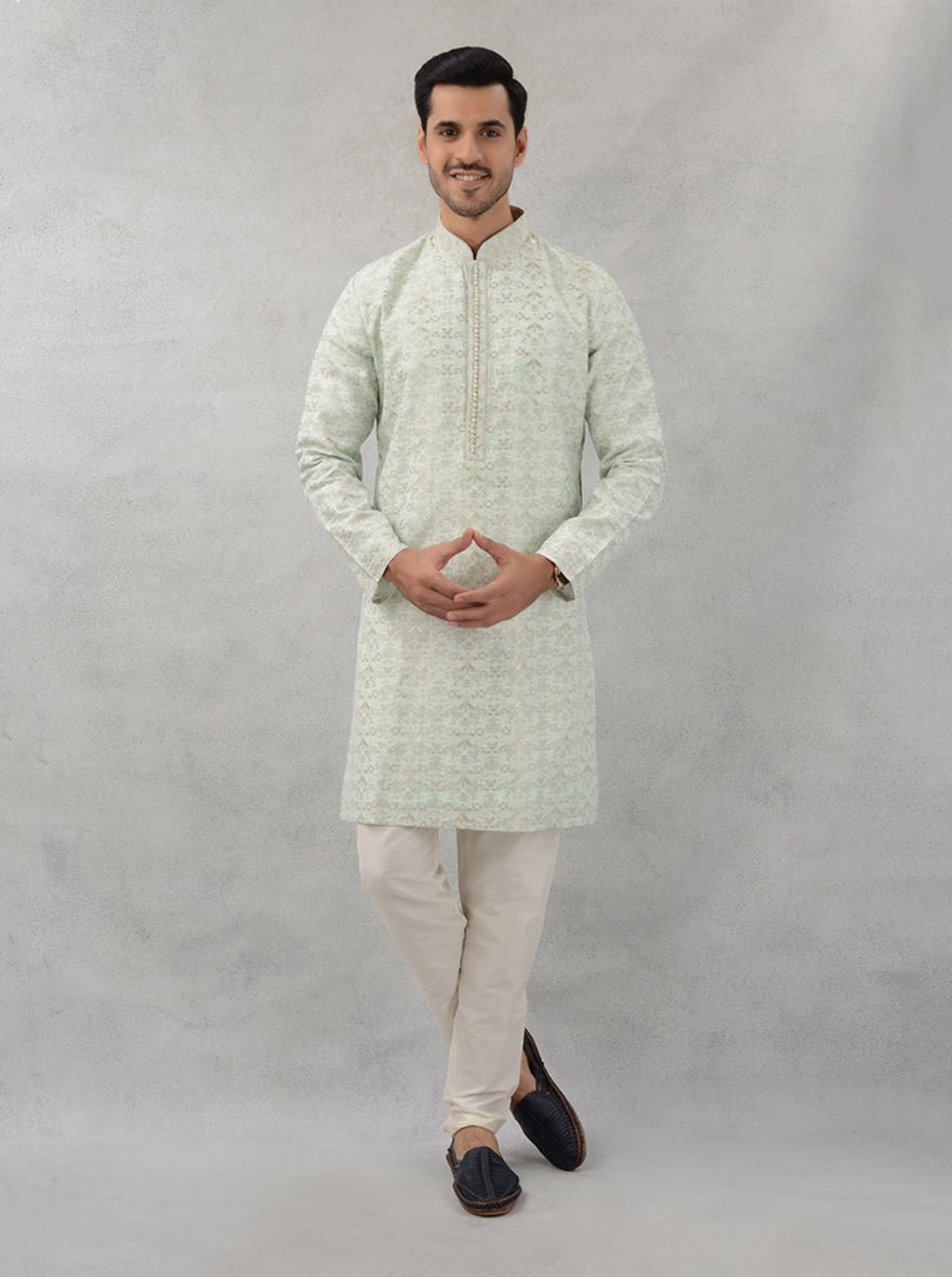 Elegant pista green kurta pajama set for men in silk jacquard fabric, perfect for festive occasions.