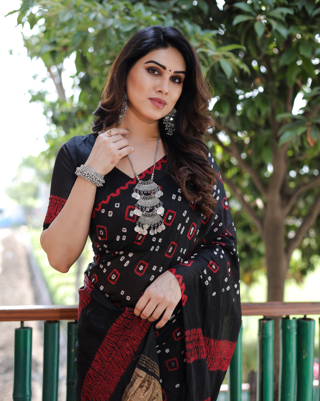 Black Bandhej silk saree with a beautiful tissue pallu and zari details, ideal for weddings and festive celebrations.