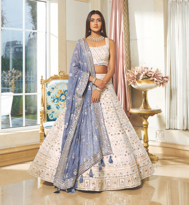 Pure georgette white lehenga set complemented by a sky-blue dupatta, ideal for creating an elegant traditional ensemble.