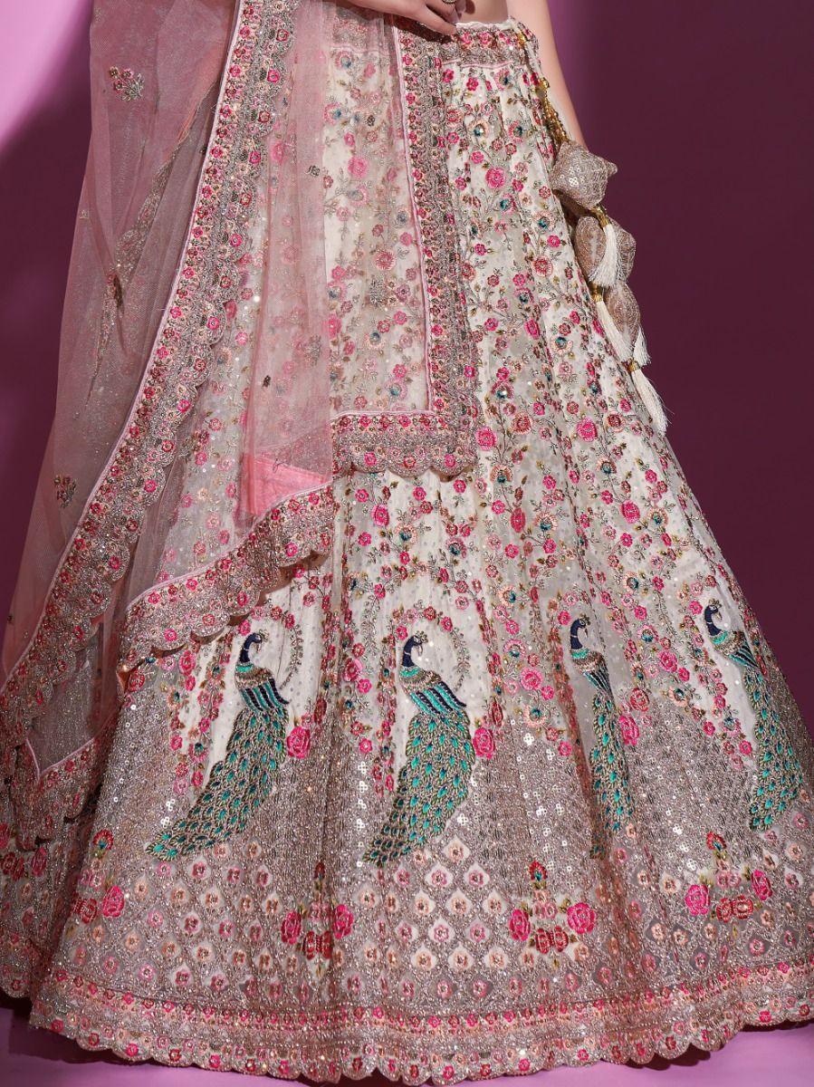 Cream lehenga choli for weddings with sequins and lace work.