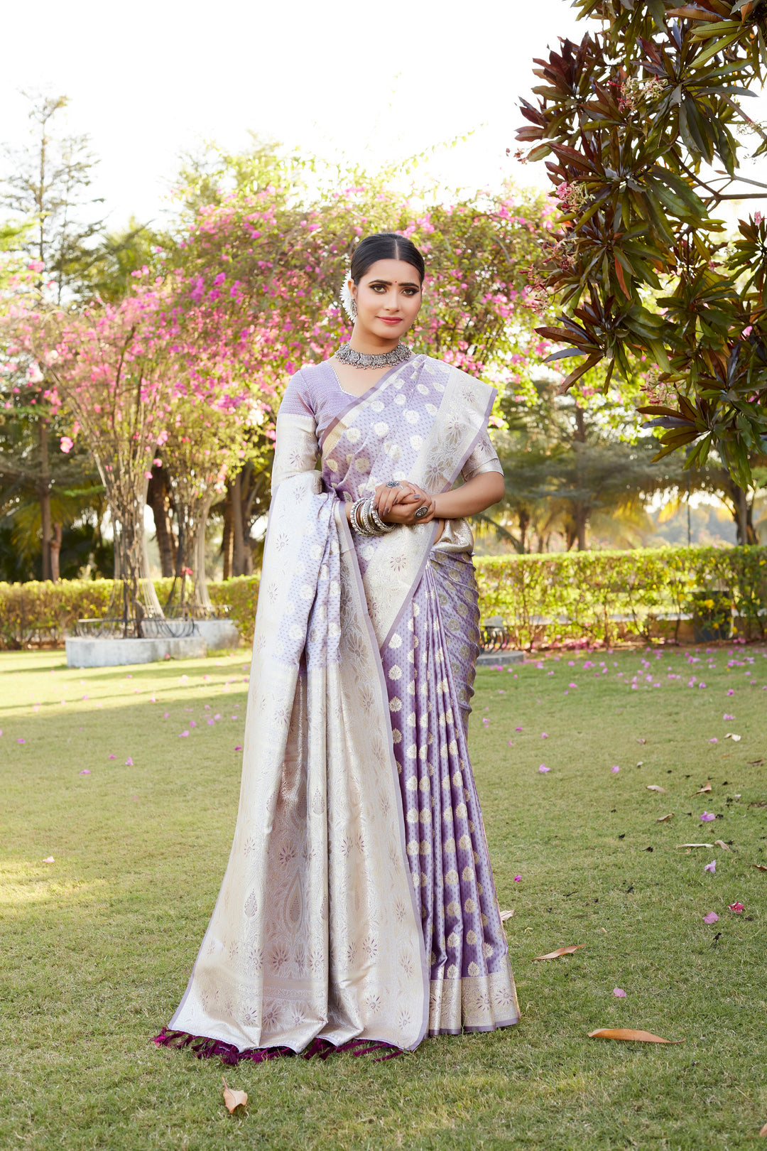 Elegant purple Kanjivaram Soft Satin Silk saree with intricate butta work and designer border for festive celebrations.