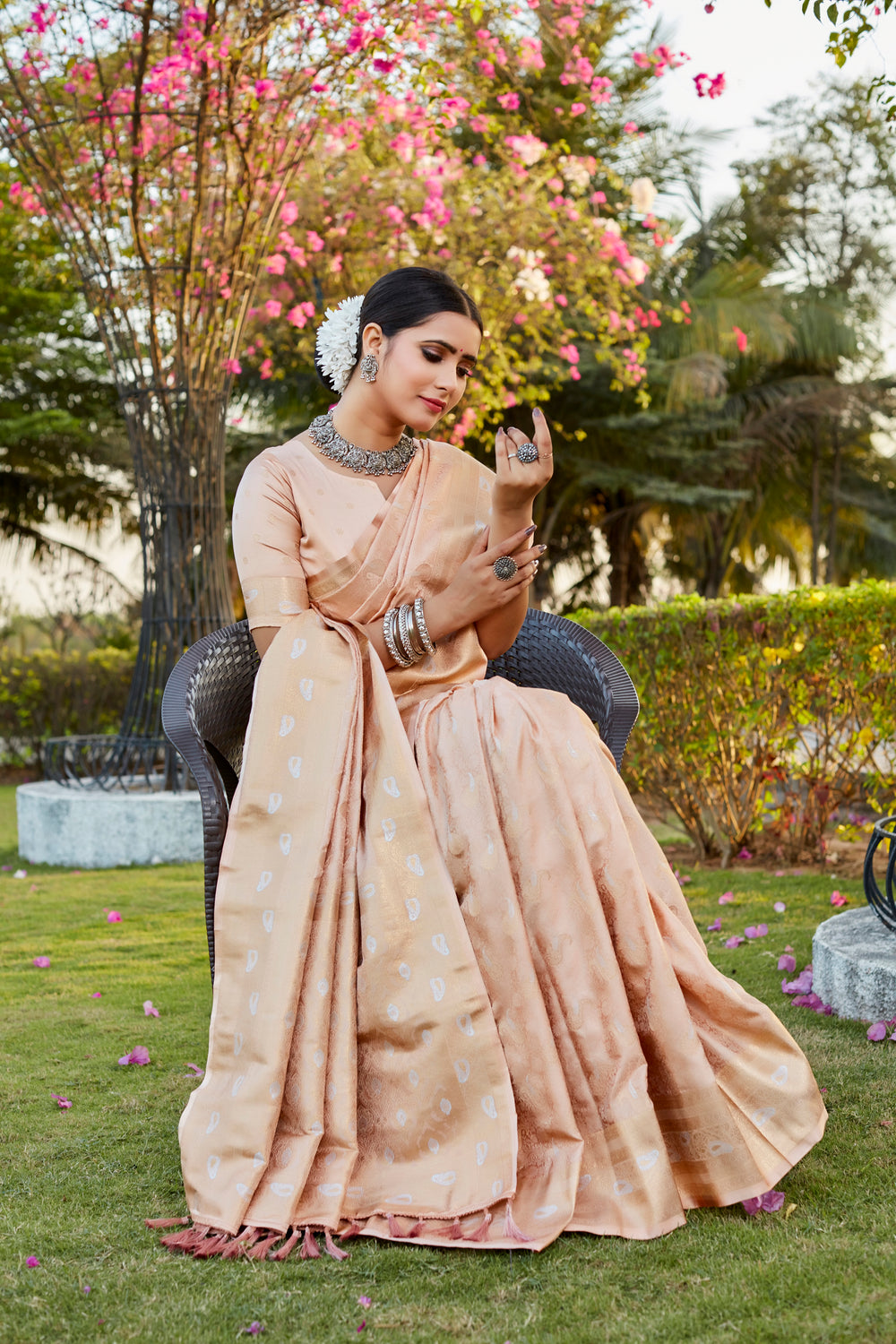 Timeless beige satin silk Kanjivaram saree featuring beautiful butta designs and a woven pallu, ideal for weddings.